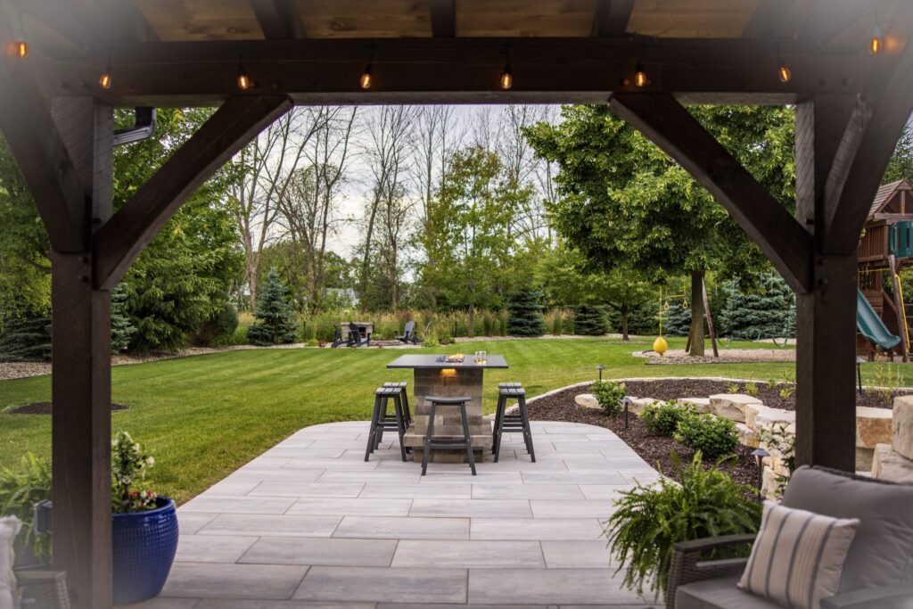 View from under the timber pavilion across the paver patio to the lawn
